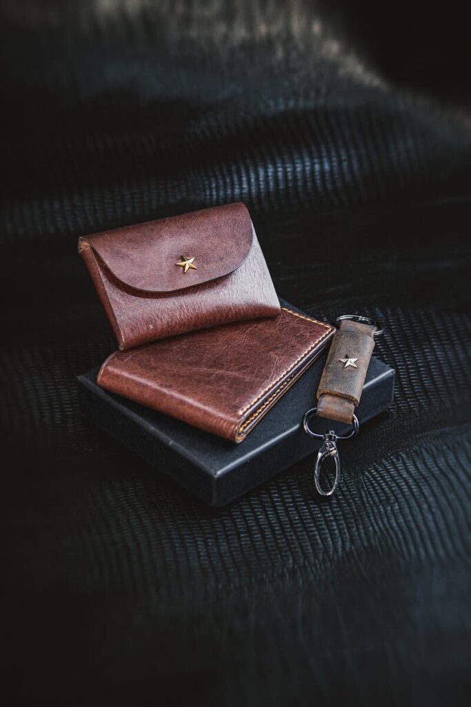 Premium leather wallet and keychain set on a black background. Sophisticated men's fashion accessory.