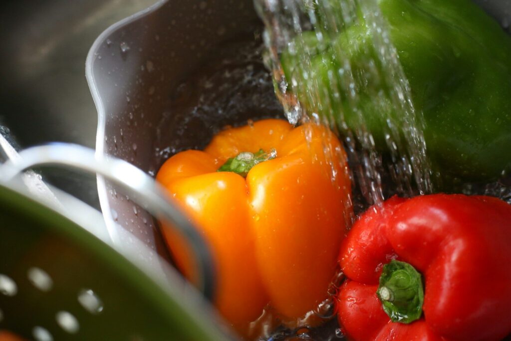 a bunch of vegetables are being washed in a sink