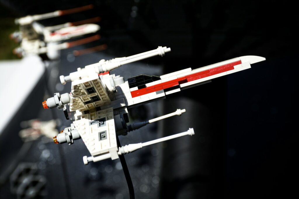 Several lego x-wing starfighters in a row.