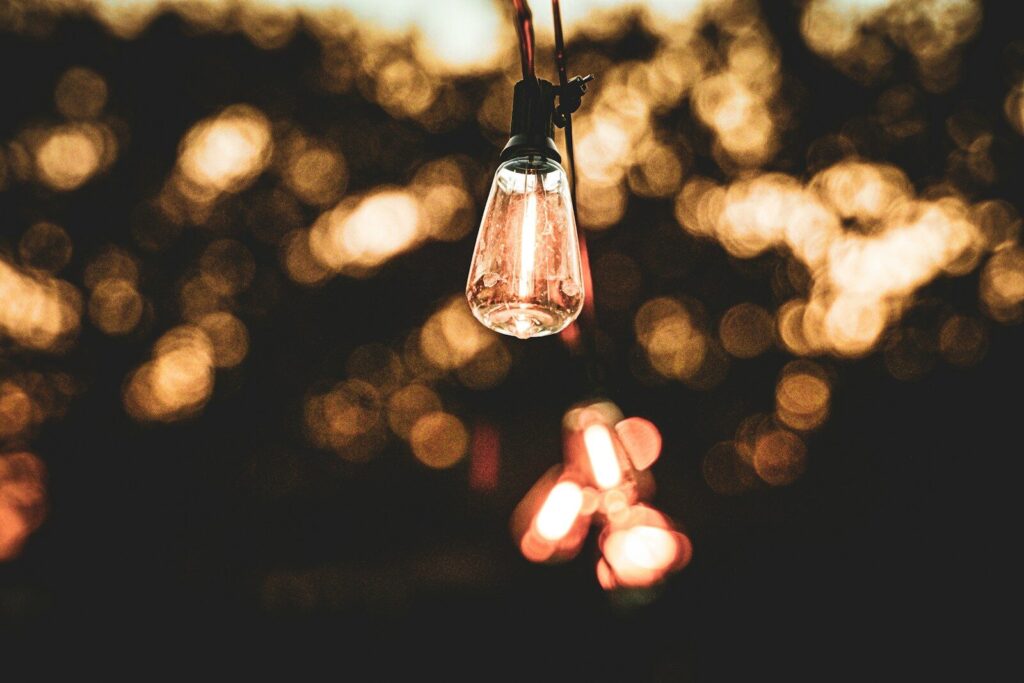 A close up of a light bulb hanging from a wire
