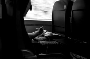 grayscale photo of person sitting on car seat