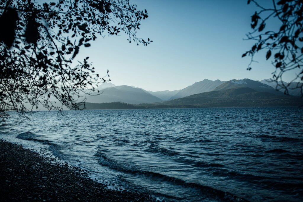 a body of water with mountains in the background