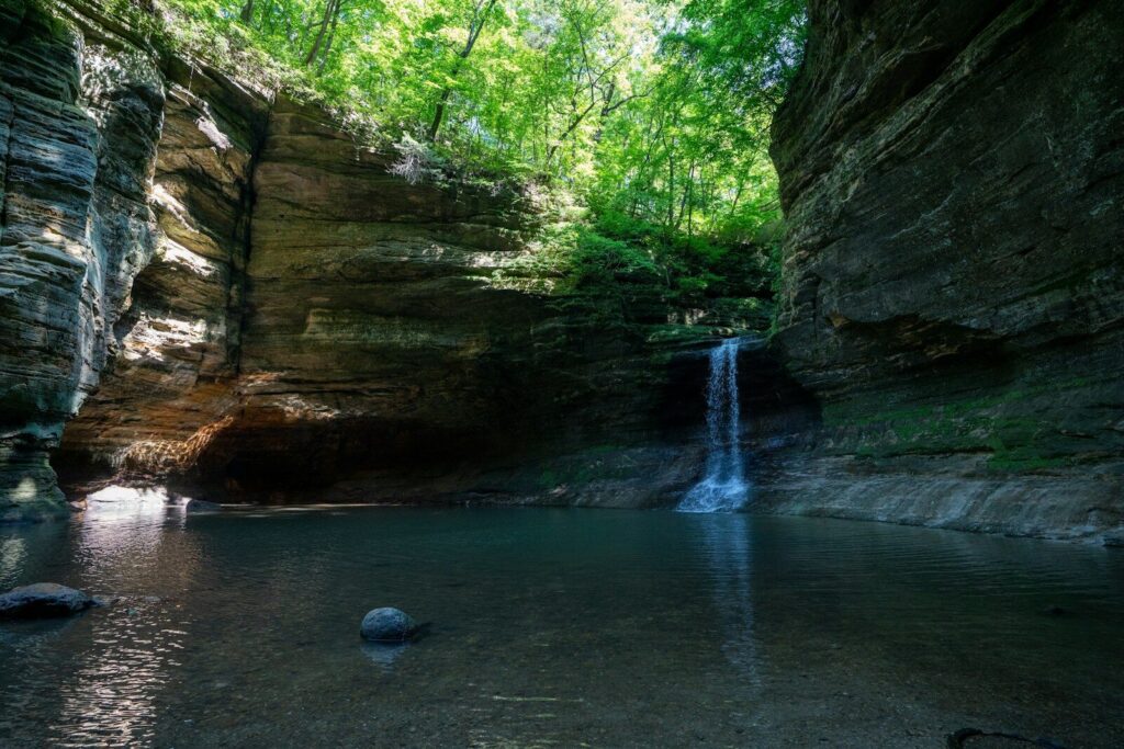 brown rock formation on river; top state parks