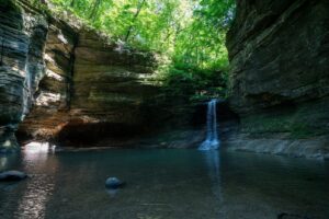 brown rock formation on river; top state parks