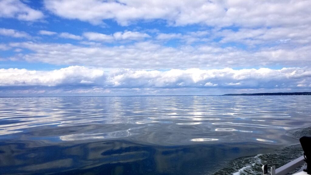 a boat traveling across a large body of water