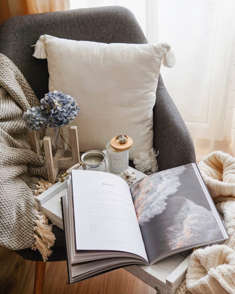 open book beside throw pillow; Home That Feels Peaceful Every Day