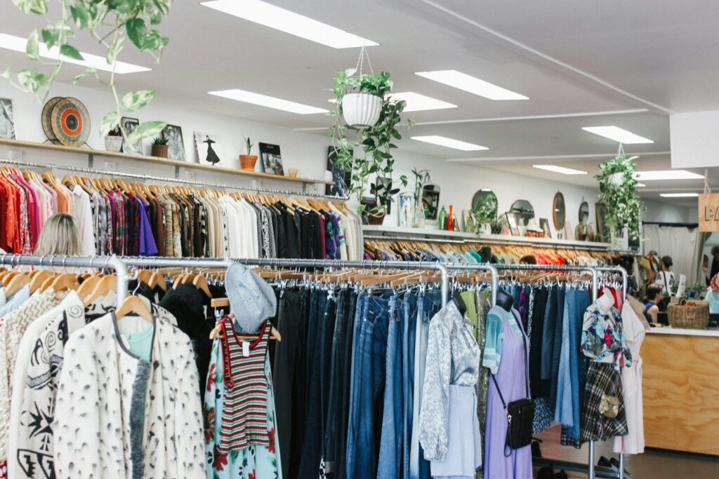 Eco-Friendly Fashion; assorted-color clothes hanged inside department store with lights turned on
